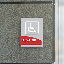 gray and red sign for elevator with handicap symbol